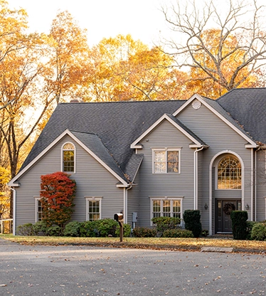 Front view of a two-story home during autumn.