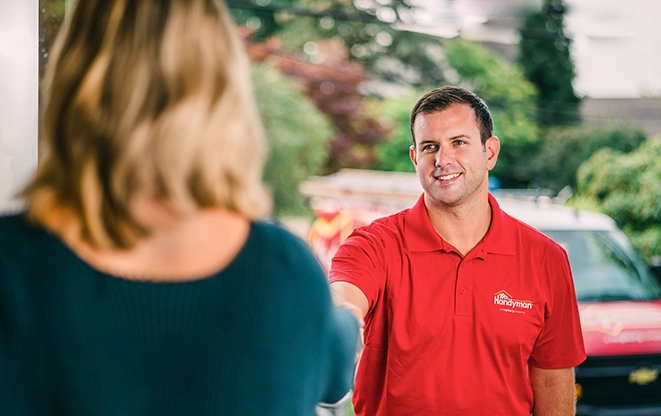 Handyman greeting customer at door.