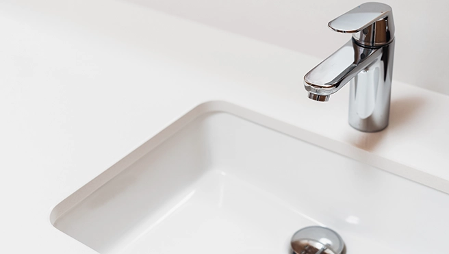 Sink with white countertop.