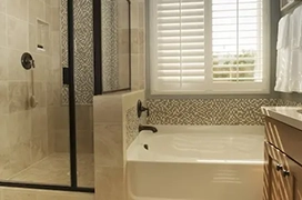Shower next to large tub.