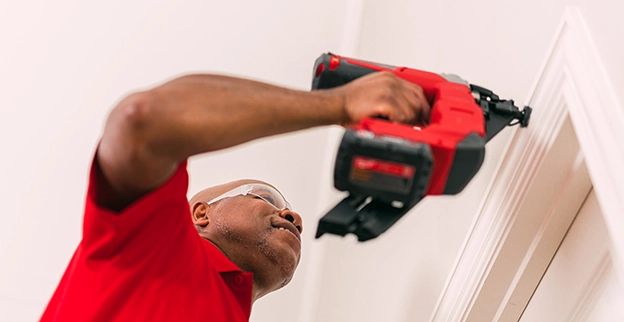 A picture of a person installing crown molding.