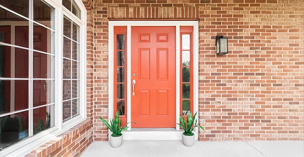 A picture of a red front door outside a home.