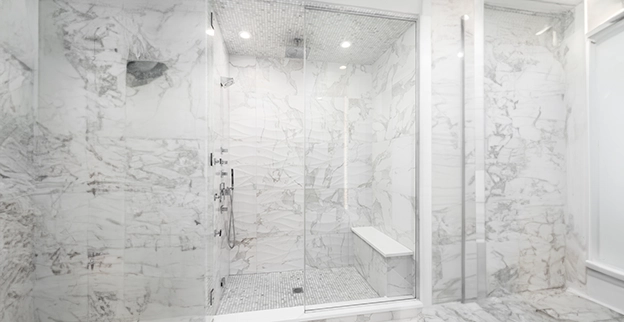Washroom shower with marble surround.