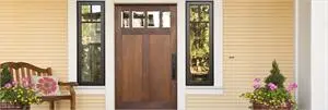 Exterior door flanked by two windows.