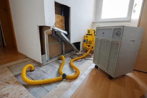 Laundry room wall being treated for moisture damage