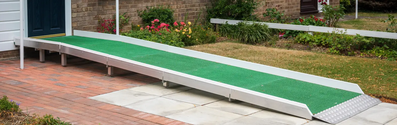 A metal wheelchair ramp installed at a home