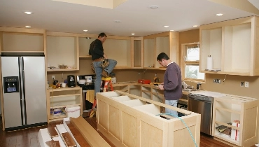 Handymen working in a kitchen.