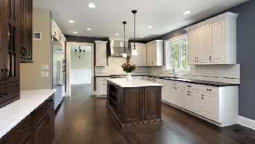 Dark wood kitchen with white cabinetry.