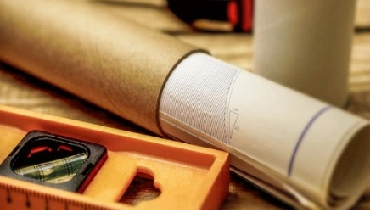 Plans rolled up with level.